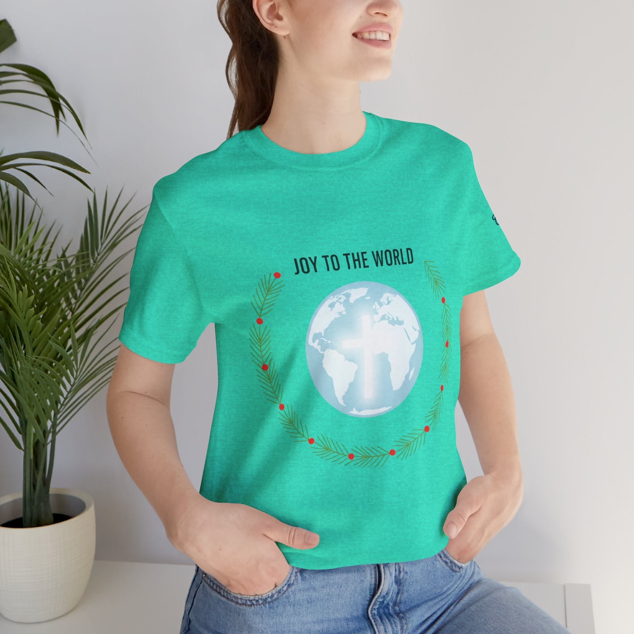 Joy to the World T-shirt – Wreath Earth Nativity Christian Christmas T-shirt for Isaiah 9:6 Holiday Faith & Festive Joy Printify