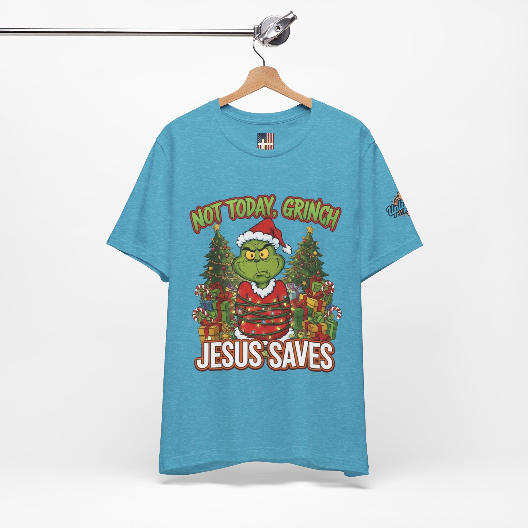 🎄 Not Today, Grinch – Jesus Saves | Funny Christian Christmas T-Shirt | Sulking Grinch & Glowing Cross | Bold Neon Faith Tee by Uplifted Gear Printify