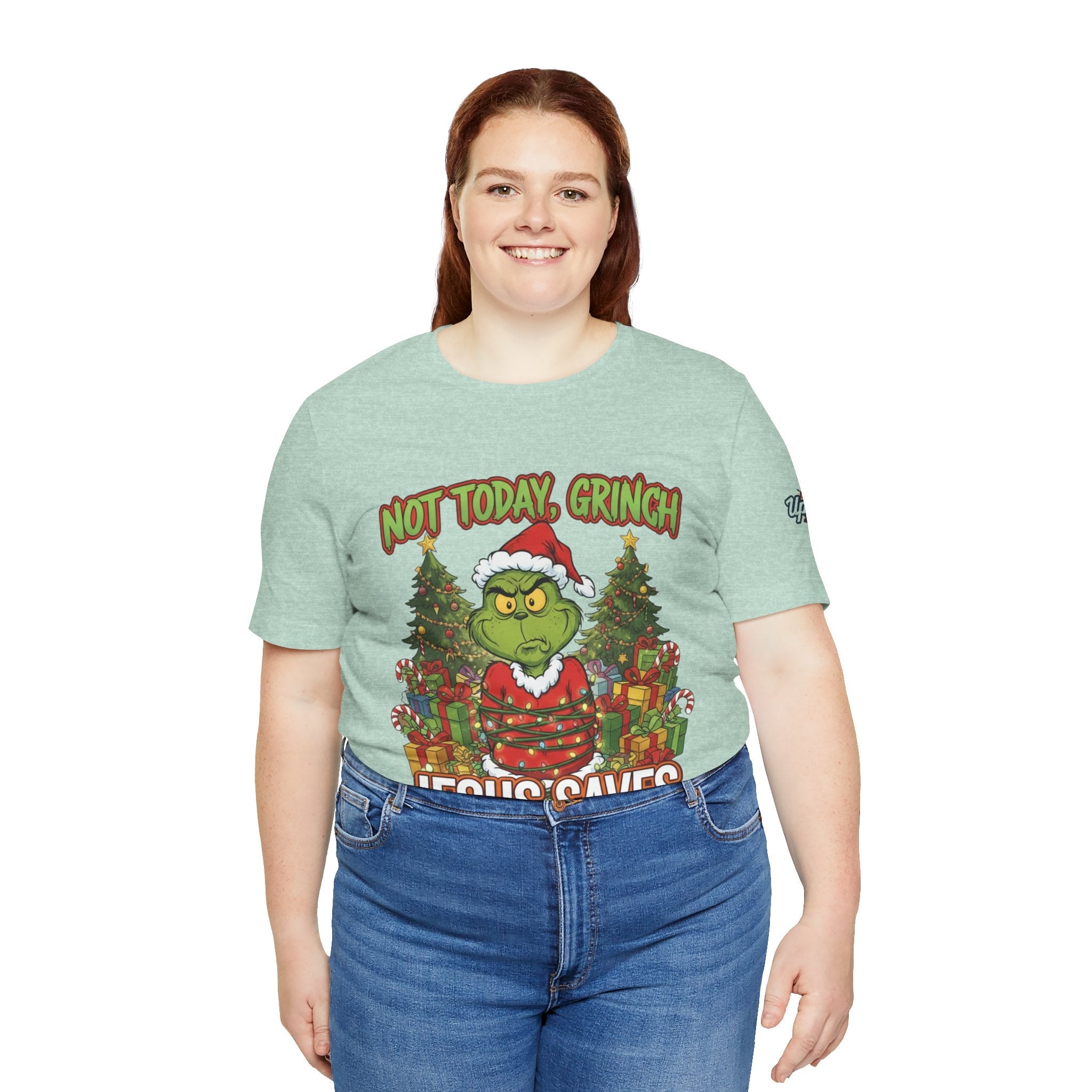 🎄 Not Today, Grinch – Jesus Saves | Funny Christian Christmas T-Shirt | Sulking Grinch & Glowing Cross | Bold Neon Faith Tee by Uplifted Gear Printify