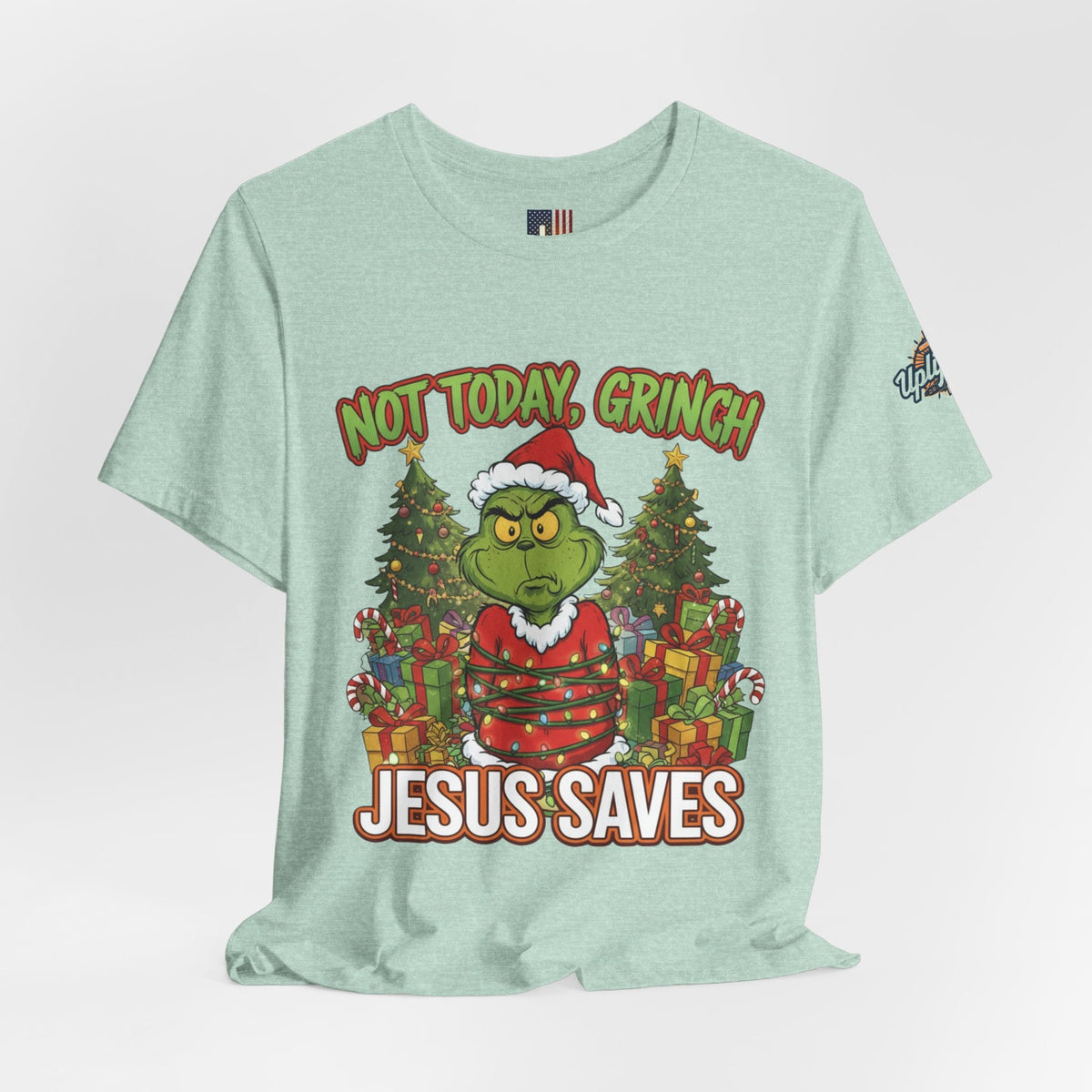 🎄 Not Today, Grinch – Jesus Saves | Funny Christian Christmas T-Shirt | Sulking Grinch & Glowing Cross | Bold Neon Faith Tee by Uplifted Gear Printify