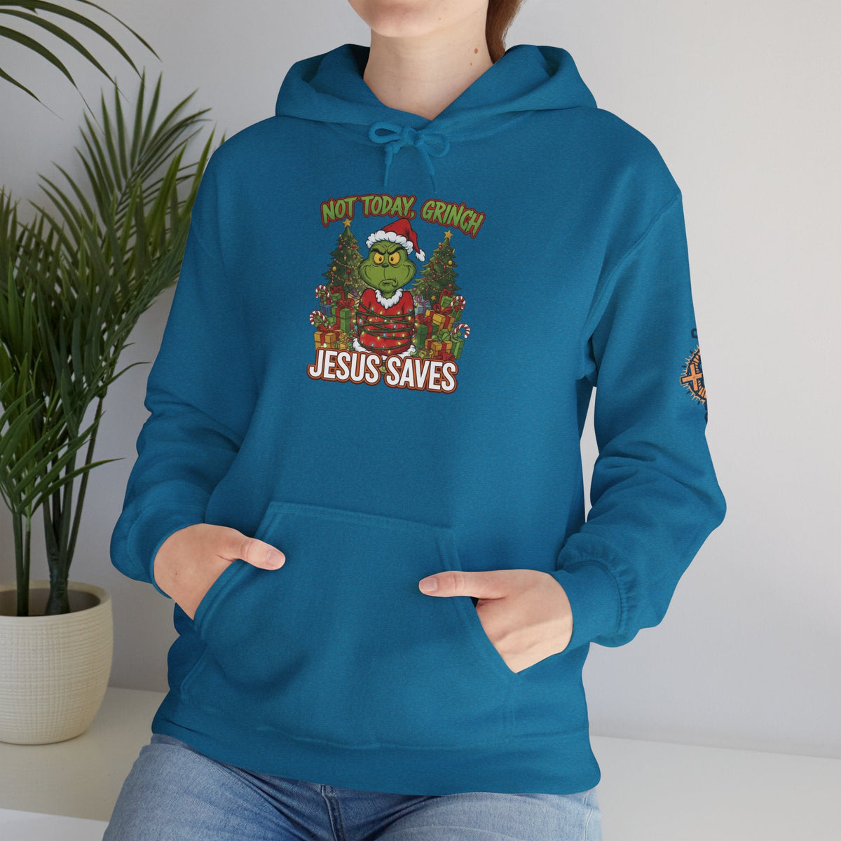 🎄 Not Today, Grinch – Jesus Saves | Funny Christian Christmas Hoodie | Sulking Grinch & Glowing Cross | Bold Neon Faith Tee by Uplifted Gear Printify