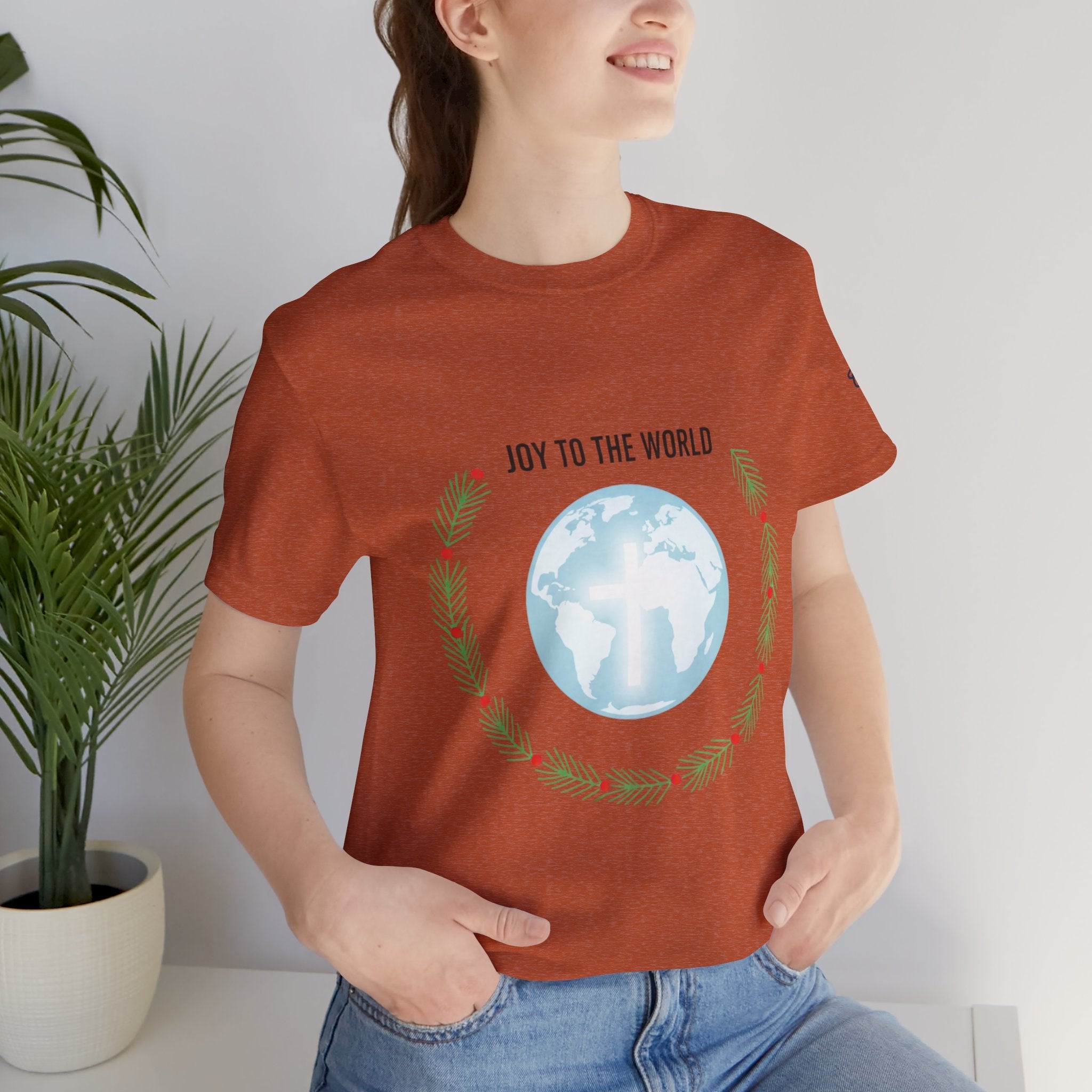 Joy to the World T-shirt – Wreath Earth Nativity Christian Christmas T-shirt for Isaiah 9:6 Holiday Faith & Festive Joy Printify