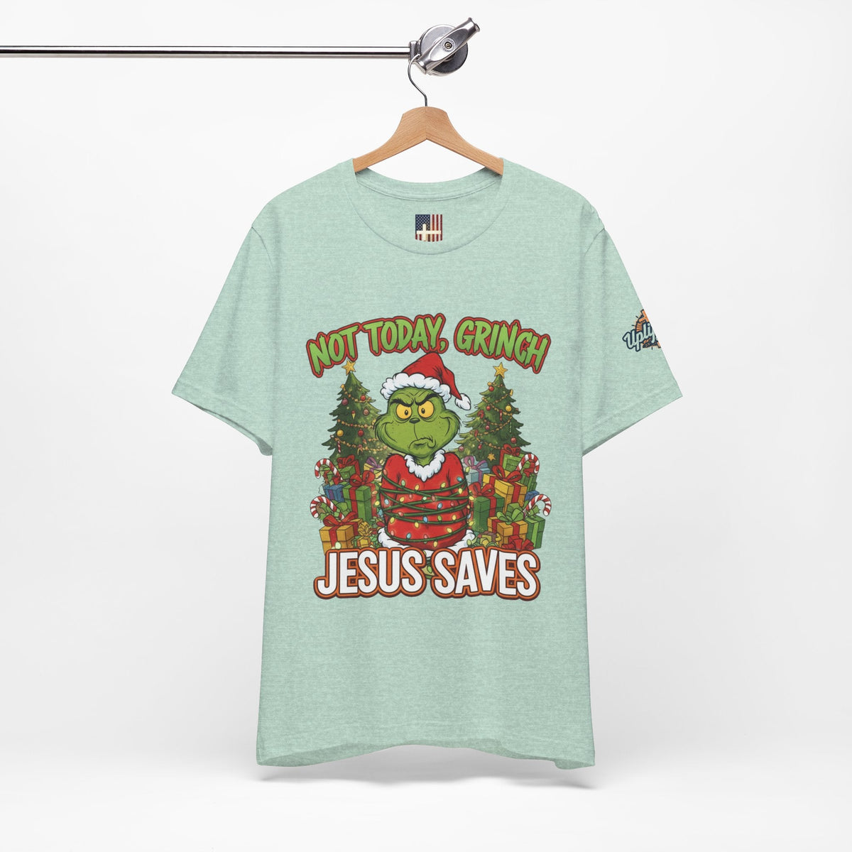 🎄 Not Today, Grinch – Jesus Saves | Funny Christian Christmas T-Shirt | Sulking Grinch & Glowing Cross | Bold Neon Faith Tee by Uplifted Gear Printify