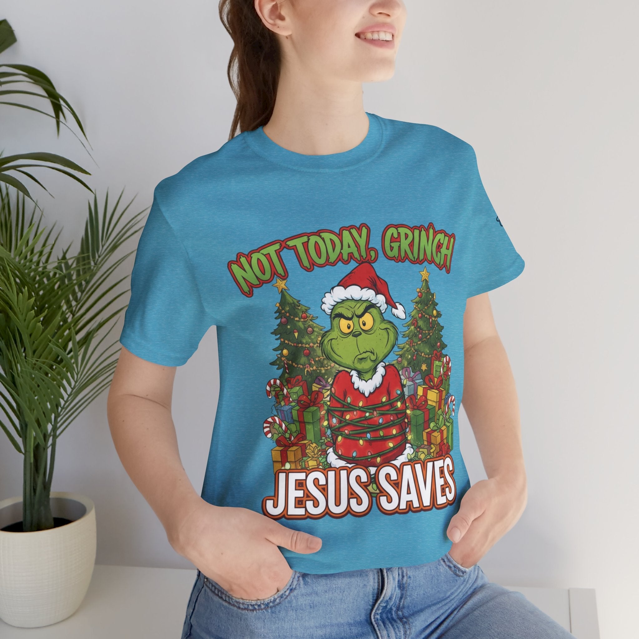 🎄 Not Today, Grinch – Jesus Saves | Funny Christian Christmas T-Shirt | Sulking Grinch & Glowing Cross | Bold Neon Faith Tee by Uplifted Gear Printify